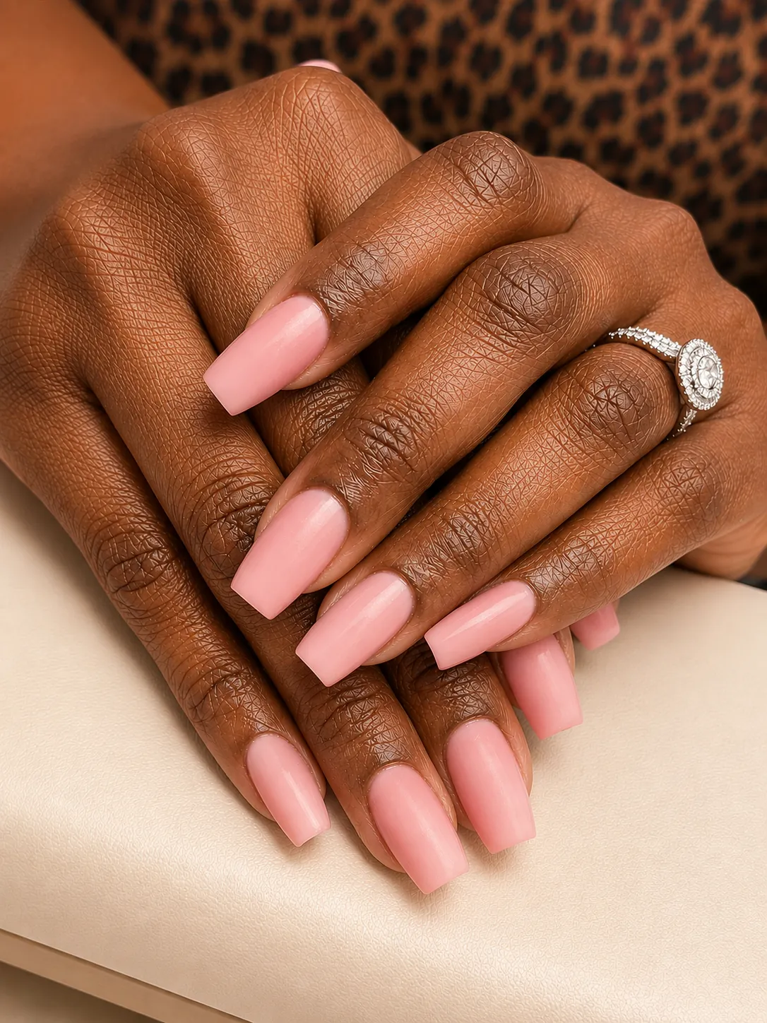 Hands with long coffin-shaped acrylic nails in soft ballet pink