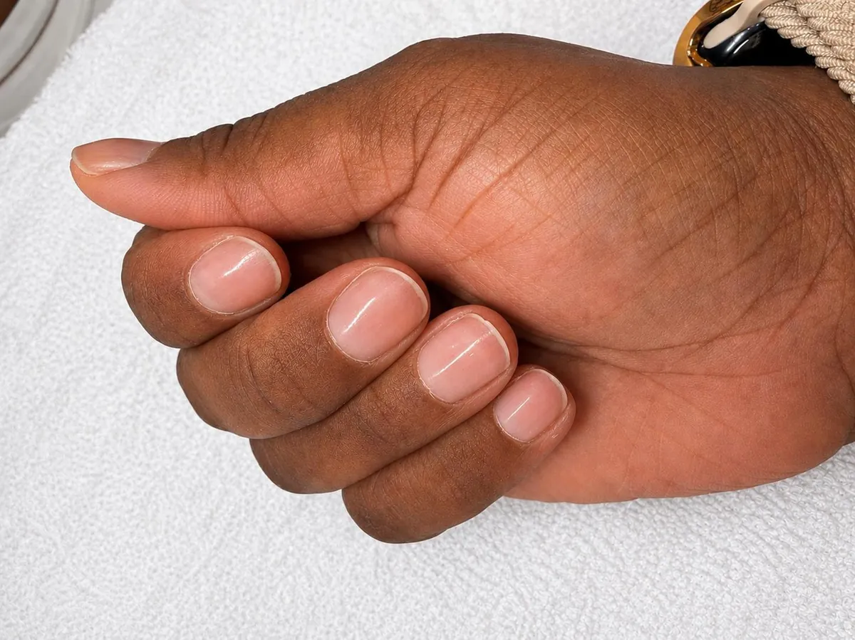 A hand with natural nails treated with the Japanese manicure, showing the luminous finish