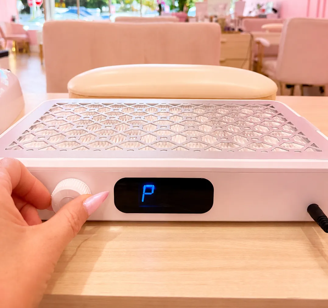 Air filtration unit beside a manicure station in the salon